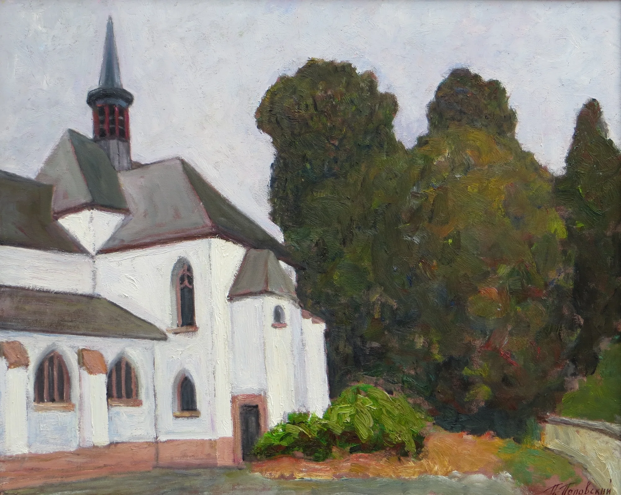 White church beside a dense mass of dark green trees beneath a pale grey sky.